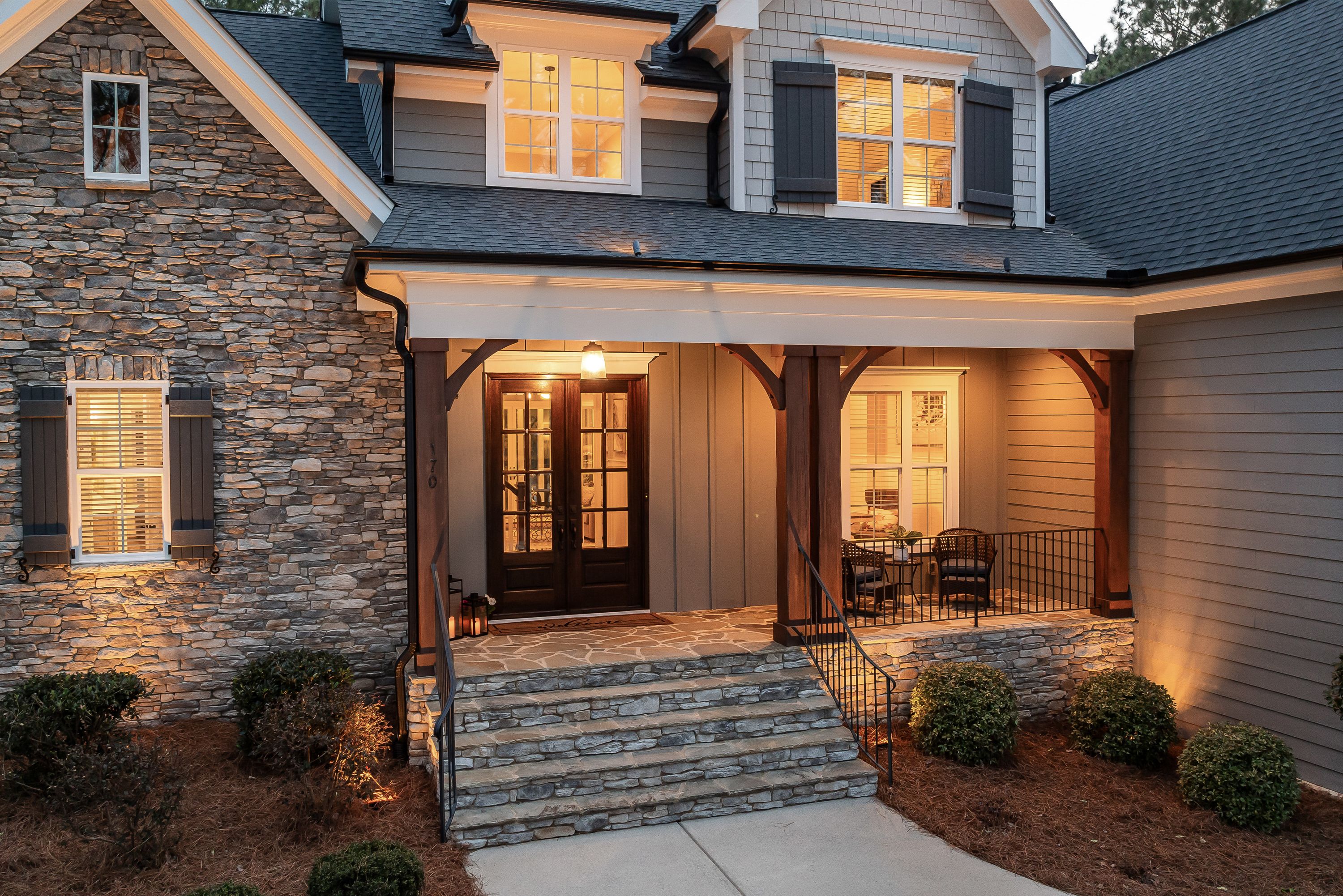 Warmly lit front entrance of a residential home at dusk